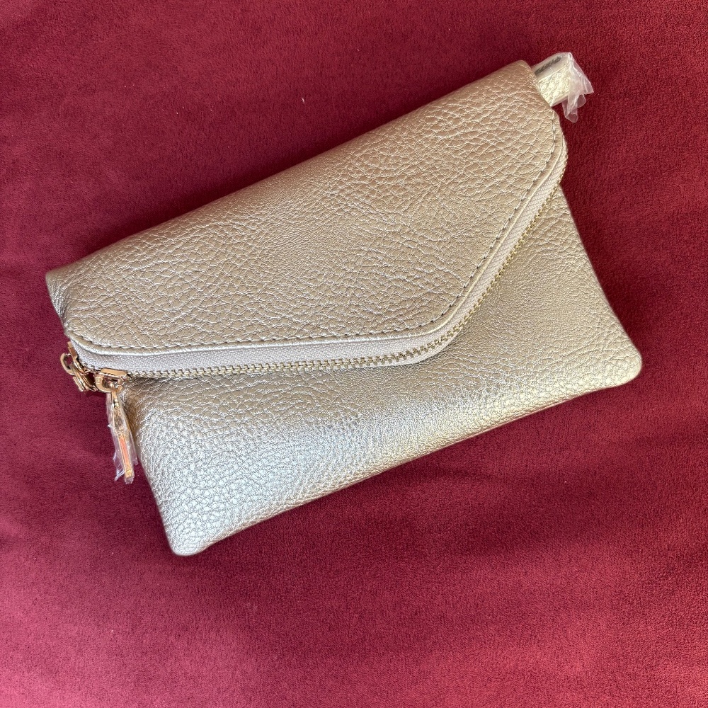 Gold tone convertible wristlet/shoulder bag. NWT